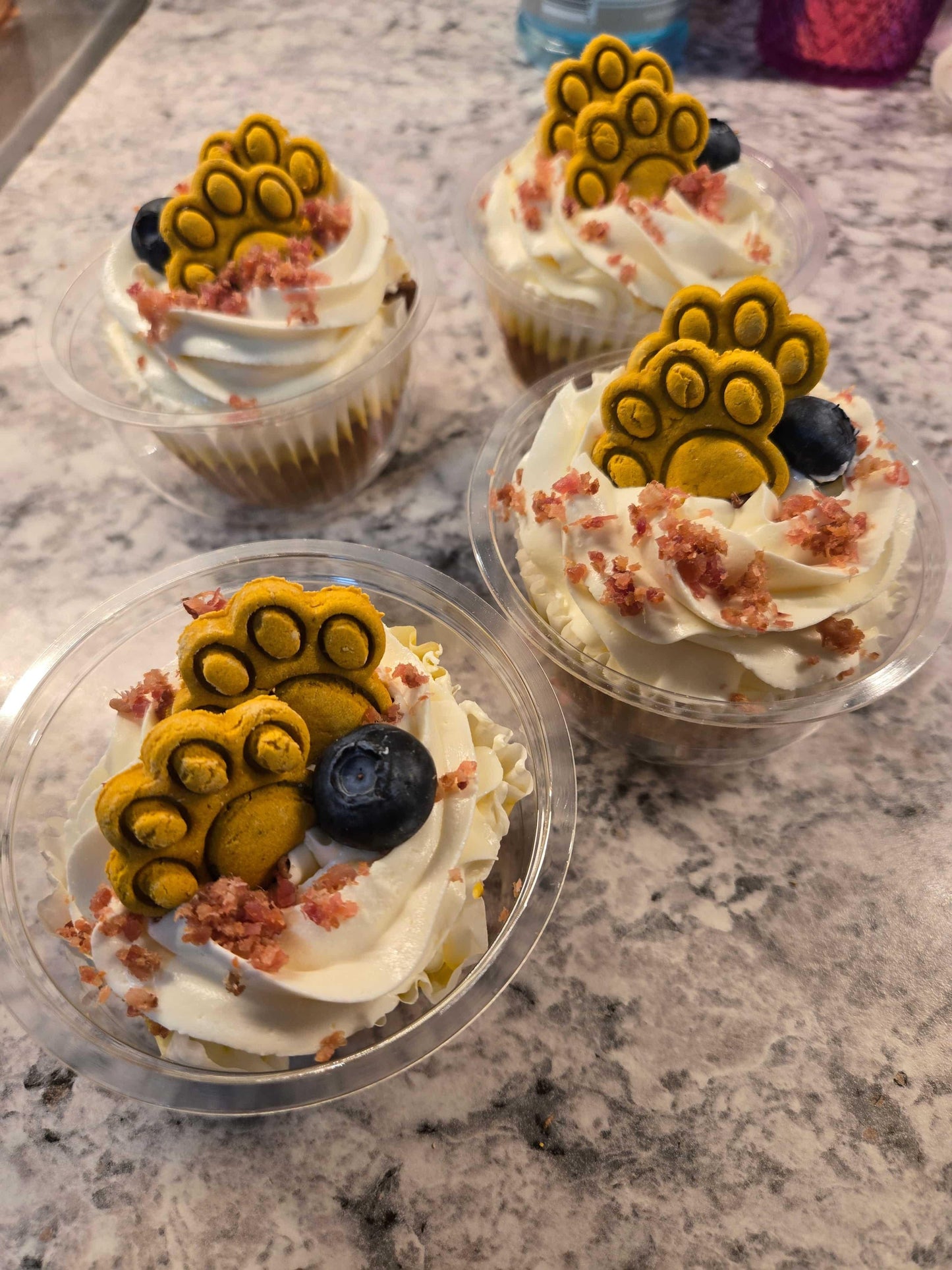 Barkday Treats pupcake with cream cheese frosting and decorated paw cookie topper, crumbled bacon, with fresh blueberries, handmade in Ontario