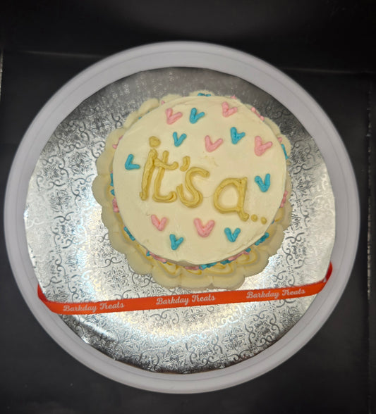 Barkday Treats dog gender reveal cake with cream cheese frosting, pink and blue heats decorations, and it's a